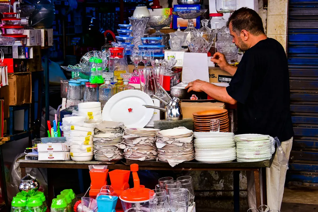 Stacked, packaged household goods representing wholesale supply categories.